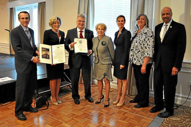 Earl Baker, third from left, receives the Chester County Chamber of Business & Industry's first ever Lifetime Achievement Award. Next to him in the center is his wife Jackie. Chamber officials and the Chester County commissioners are also shown.