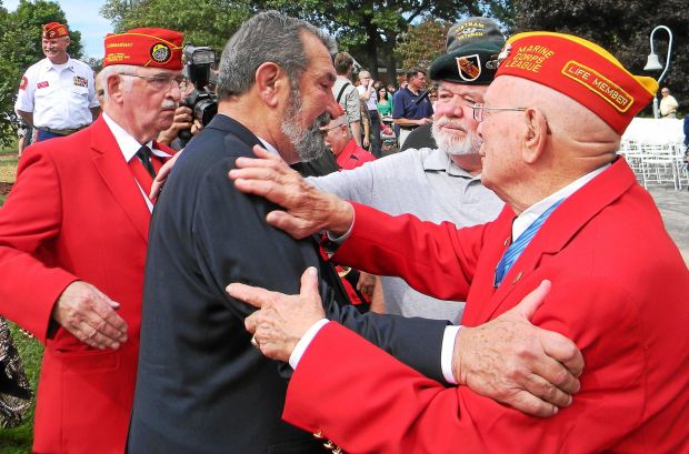 Harry Price, center, father of the late Navy SEAL Job Price, is greeted by veterans after speaking at the dedication of the new Gold Star memorial at the Freedoms Foundation in Valley Forge. (MediaNews Group File Photo)