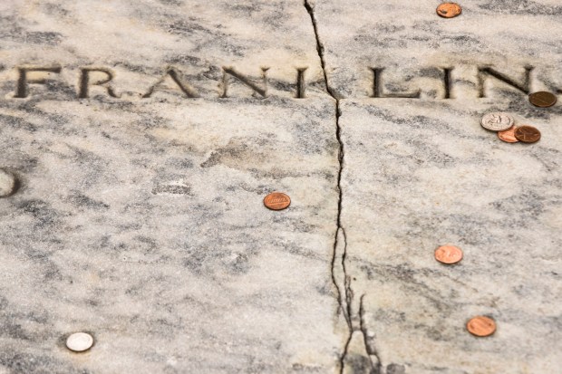 FILE - In this Tuesday, Nov. 15, 2016, file photo, a crack runs through Benjamin Franklin's a gravestone at the Christ Church Burial Ground in Philadelphia. Repairs are complete on Franklin's damaged gravestone. KYW-TV reported Christ Church will hold an unveiling Tuesday, May 23, 2017, of the repaired slab on the grave that holds Franklin and his wife, Deborah. (AP Photo/Matt Rourke, File)