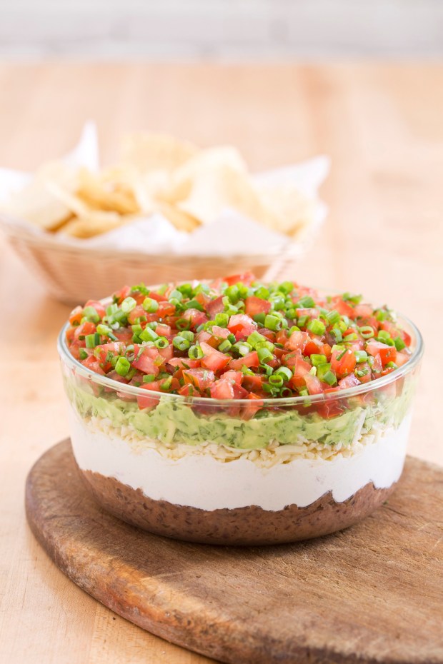 Although not a traditional Mexican dish, the recipe for 7-Layer Dip uses many flavors and ingredients to create a party-worthy appetizer. (Courtesy of America's Test Kitchen)