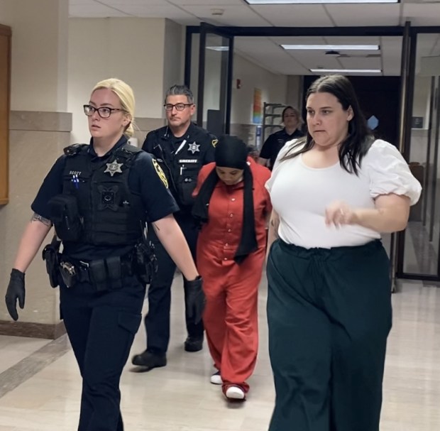 Jahme Barnes, in red prison jumpsuit, is escorted by sheriff's deputies from a Montgomery County courtroom after pretrial hearing on June 18, 2024. She is accompanied by Alana Hook, chief of policy and social services for the Montgomery County Office of Public Defender. (Photo by Carl Hessler Jr. - MediaNews Group)