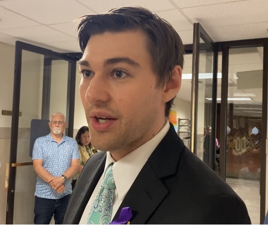 Man in suit coat and tie in hallway