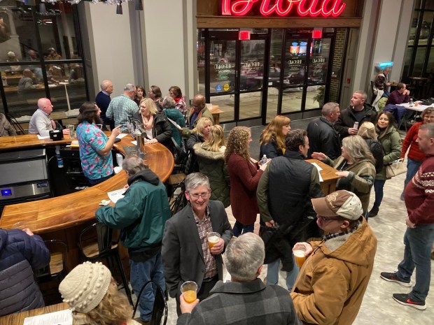 Patrons drink beer and socialize at the grand opening of Cinema Brewery in Souderton's Broad Theater. (John Worthington - MediaNews Group)