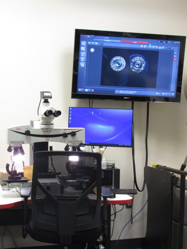 A comparison macroscope consists of two microscopes mounted side-by-side. This allows the firearms examiner to view two pieces of evidence side by side under the same magnification and lighting. Firearms Examiners are able to make identifications or eliminations by utilizing the comparison macroscope and analyzing these microscopic markings. (Courtesy of Chester County)