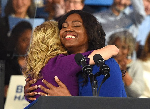 Springfield Pharmacy owner Chichi Ilonzo Momah gets a hug from the first lady. (PETE BANNAN-DAILY TIMES)