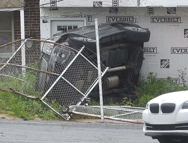 Here's another piece of the puzzle from the series of events Tuesday that started in Delaware with an episode in Upper Chichester Township and ended in Chester: An overturned GMC vehicle against a home behind 12th and Kerlin streets just off Interstate 95 in Chester. (PETE BANNAN-DAILY TIMES)