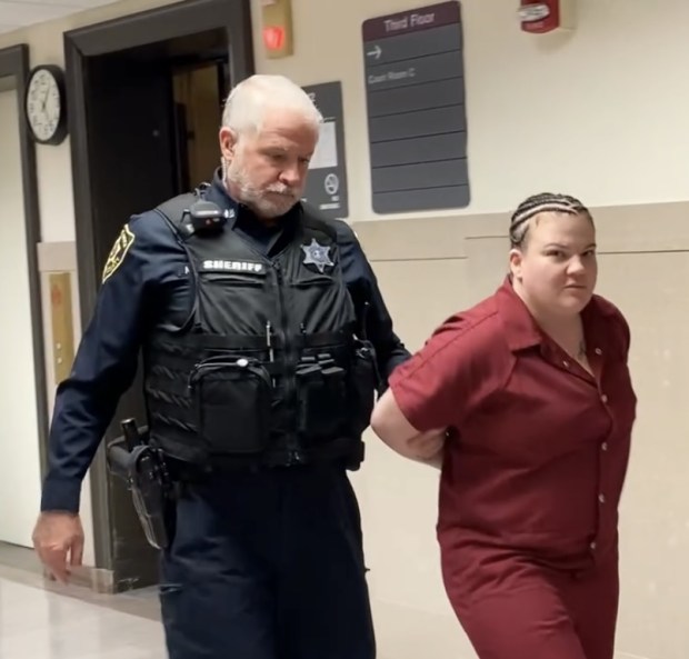 Katherine Lynn Emel, 31, is escorted by a deputy sheriff to her arraignment hearing in Montgomery County Court on April 8, 2024, on robbery- and homicide-related charges. (Photo by Carl Hessler Jr. - MediaNews Group)