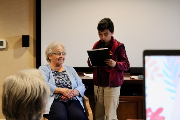 Berks Christian School fourth-grader Jason B. presents the biography of his adopted grandparent, Keystone Villa at Douglassville resident Chris Jones. (Courtesy of Keystone Villa at Douglassville)