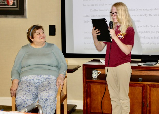 Berks Christian School student Annabelle S., presents the biography of her adopted grandparent, Keystone Villa at Douglassville resident Christine Gubernot. (Courtesy of Keystone Village at Douglassville)