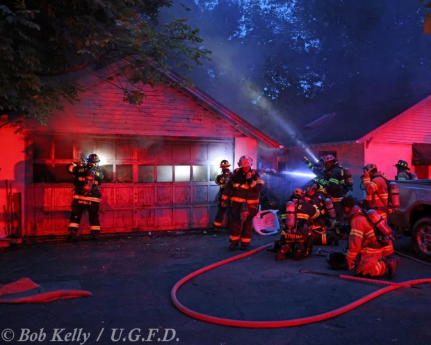 Upper Gwynedd Fire Department (Station 80) and North Penn Volunteer Fire Company (Station 62) firefighters work together at a fire scene. (Photo by Bob Kelly for UGFD)