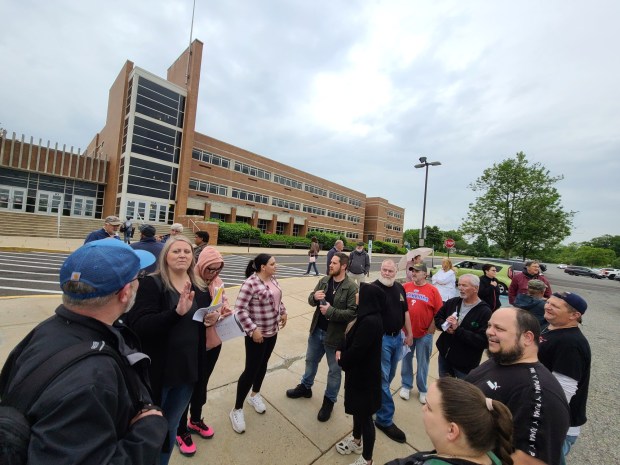 Roughly two dozen parents and community members congregate outside North Penn High School ahead of a school safety forum on Tuesday, May 14 2024. (Dan Sokil - MediaNews Group)