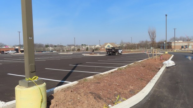 Contractors install new landscaping alongside fresh curbs and paving in the former Towamencin Village Shopping Center, as seen on Tuesday, Feb. 27 2024. (Dan Sokil - MediaNews Group)