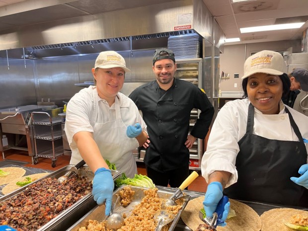 Christina Fenton, Matthew Marshall, and Tamika Malachi prepare food in the production kitchen at Manna on Main Street in Lansdale. Fenton and Malachi were trainees in Manna's Common Grounds Training Program at the time, and are now graduates of the program. Marshall is on Manna's culinary staff. (PHOTO COURTESY OF MANNA ON MAIN STREET)