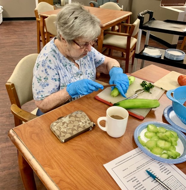 Marie Karkoska, 92, prepares vegetables at SarahCare.(Courtesy of Donna Famous)