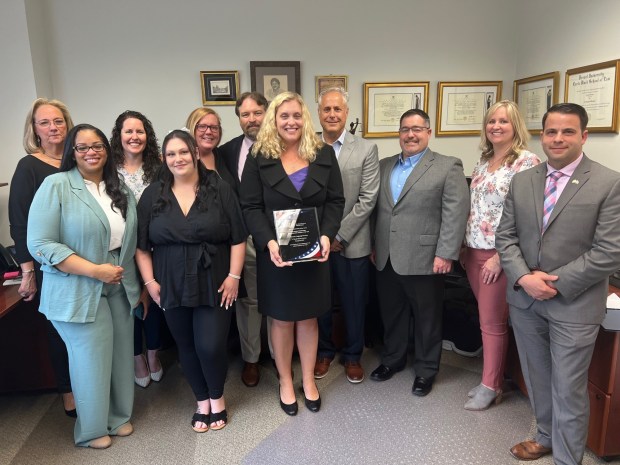 Employees and guests were on hand Thursday, May 9 for the presentation of the SBA Eastern Pennsylvania District's 2024 Entrepreneurial Success of the Year Award to Phoenix Language Services of Whitpain Township. The award was presented to J. Nicole Martin Lawton, president and CEO, center, by Steve Dixel, SBA Eastern Pennsylvania director. (Photo Courtesy SBA Eastern Pennsylvania District)