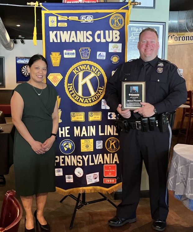 Lower Merion Police Officer Michael Pleasants receives an 'Officer of the Year' award from Sarah Zulueta, Kiwanis Club ofthe Main Line President. (Photo courtesy of Main Line Kiwanis Club)