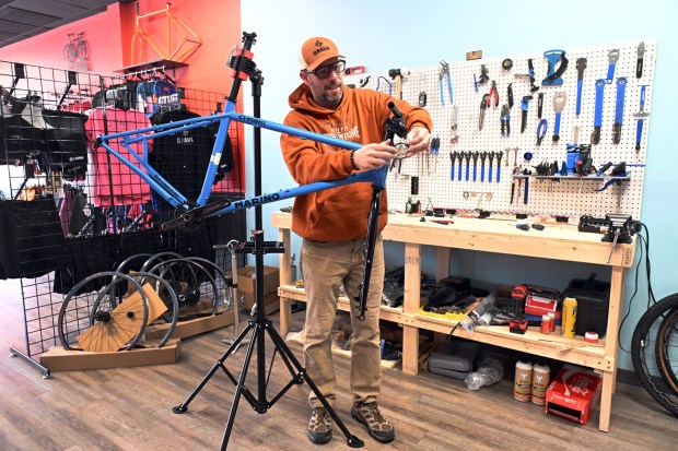 Aaron Johnson, owner of the Go Grava bike shop, installs shifter cables on a bike prior to the store's grand opening at 840 N. Park Road, Wyomissing. (BILL UHRICH - MEDIANEWS GROUP)