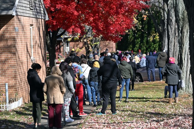 Residents in Glenside take part in a Helping Harvest food distribution at the Glenside Homes. (BILL UHRICH - READING EAGLE)