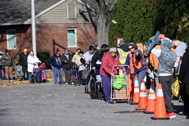 Residents in Glenside take part in a Helping Harvest food distribution at the Glenside Homes. (BILL UHRICH - READING EAGLE)