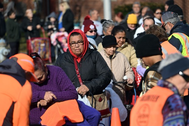 Residents in Glenside take part in a Helping Harvest food distribution at the Glenside Homes. (BILL UHRICH - READING EAGLE)