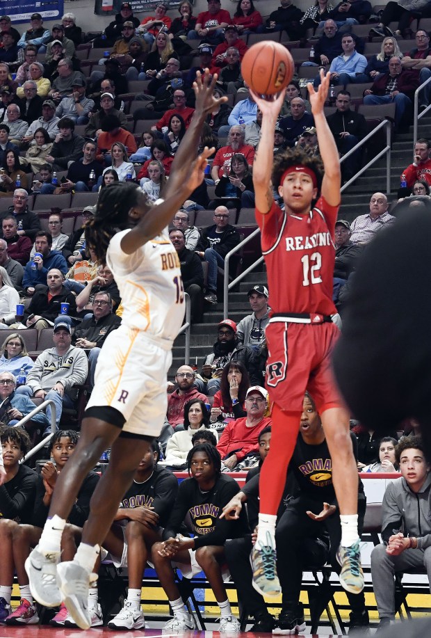 Reading High's Aris Rodriguez hits a corner 3-pointer against Roman Catholic in the Red Knights' 63-56 overtime win in the PIAA Class 6A Final Saturday in the Giant Center. (BILL UHRICH - READING EAGLE)