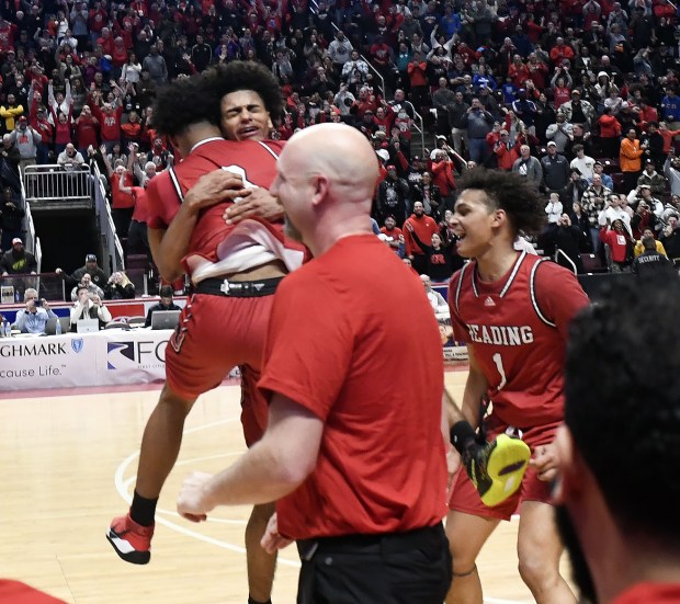 Reading High's Ruben Rodriguez and Amier Burdine along with the Red Knights celebrate following their 63-56 overtime win over Roman Catholic in the PIAA Class 6A Final Saturday in the Giant Center. (BILL UHRICH - READING EAGLE)