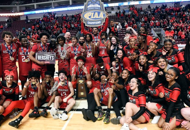 The Red Knights pose with the trophy following their 63-56 overtime win over Roman Catholic in the PIAA Class 6A Final Saturday in the Giant Center. (BILL UHRICH - READING EAGLE)