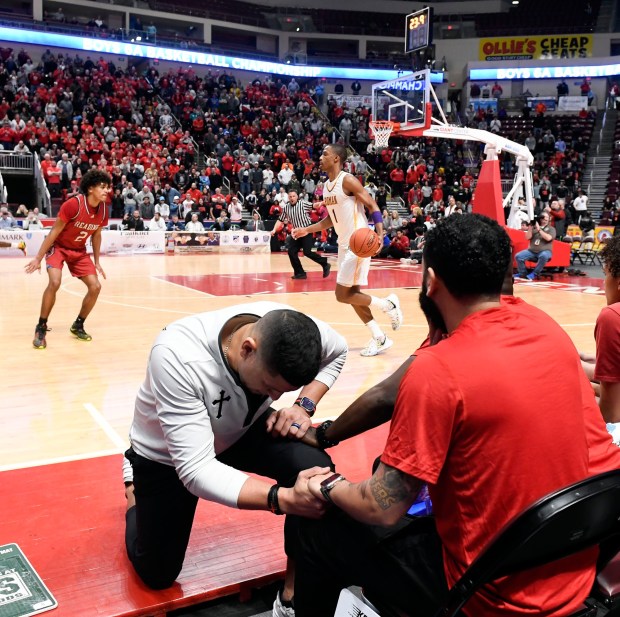 Reading High's Rick Perez says a prayer near the end of regulation that wasn't answered until overtime against Roman Catholic in Red Knights' 63-56 win in the PIAA Class 6A Final Saturday in the Giant Center. Ruben Rodriguez guards the Cahillite's Xzayvier Brown as he brings the ball up court with 24 seconds left. (BILL UHRICH - READING EAGLE)