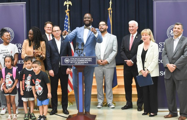 State Sec. of Education and former Reading School District Superintendent Dr. Khalid Mumin leads a Red Knights cheer with the 148 new teachers gathered at Millmont Elementary School Friday for orientation. Gov. Josh Shapiro is at left. (BILL UHRICH - READING EAGLE)