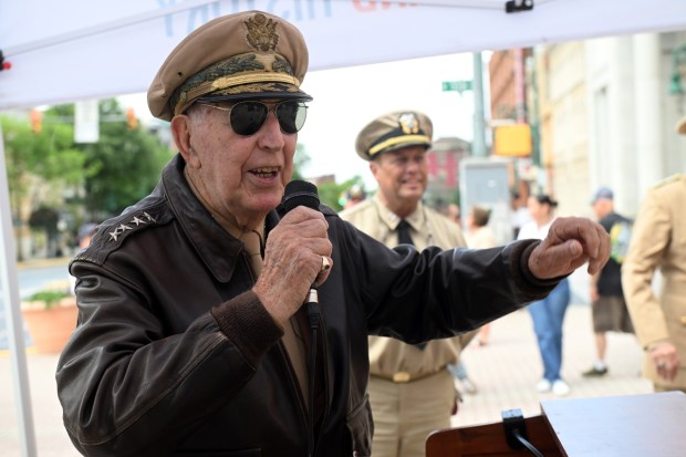 Man in vintage military uniform gesturing.