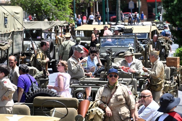 Crowds mingle with reenactors during the WWII Weekend Parade on Friday, June 7, 2024 in downtown Reading. The event marked the official kickoff for the Mid-Atlantic Air Museum's 33rd Annual World War II Weekend at Reading Regional Airport through Sunday. (BILL UHRICH - READING EAGLE)