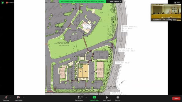 Towamencin's board of supervisors, inset, see revised plans for a new building split between a Chipotle restaurant, bottom center left, and Mattress Warehouse, center right, with a new pedestrian bridge highlighted in brown and running toward adjacent parking lots, in 2022. (Screenshot of online meeting)